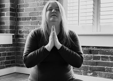 Amy Little in meditation pose